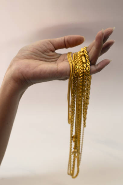 hand holding gold jewelry,Include Clipping Path.