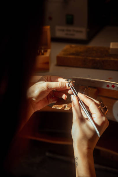 Woman jeweller looking diamond gemstone